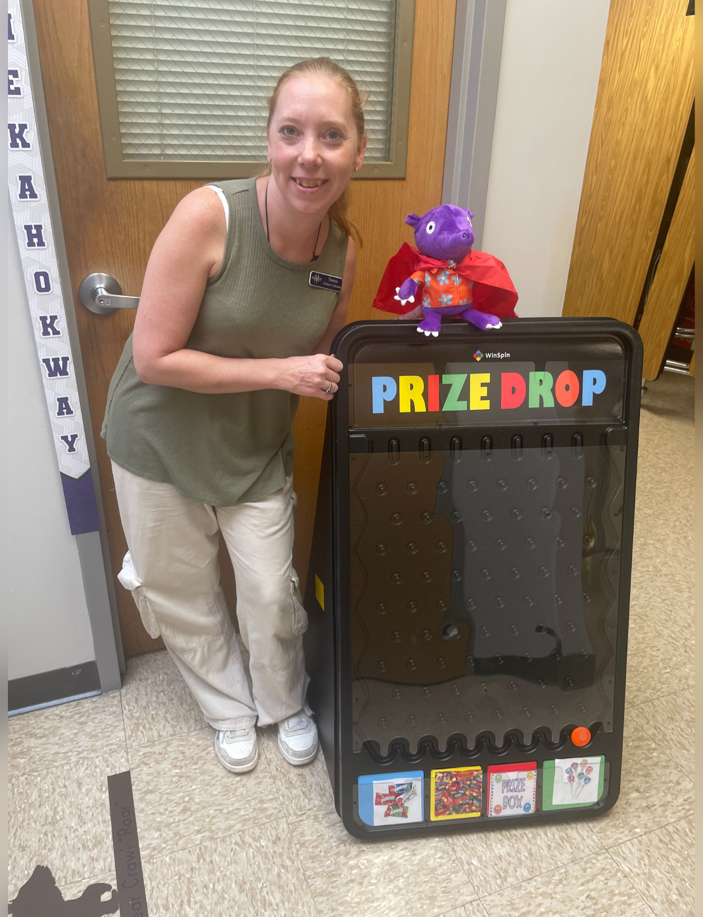 MVLD Children's Librarian Theresa Beck with the prize drop game and a summer reading stuffie.