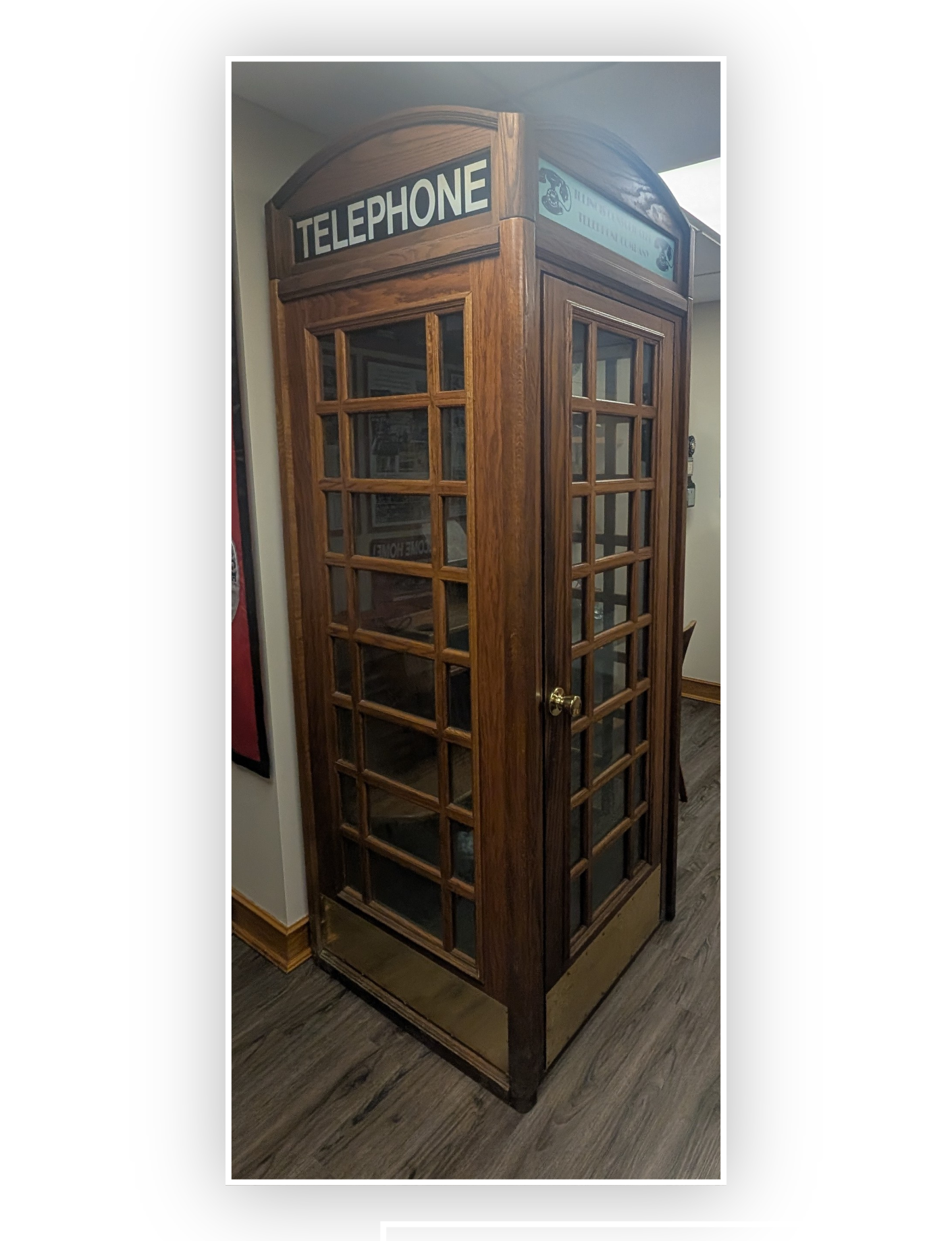 an antique wooden phone booth