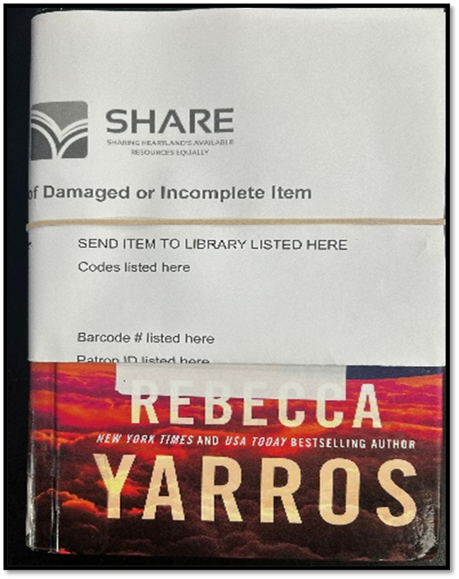 Damaged book with the form affixed with rubber bands, covering the barcode.