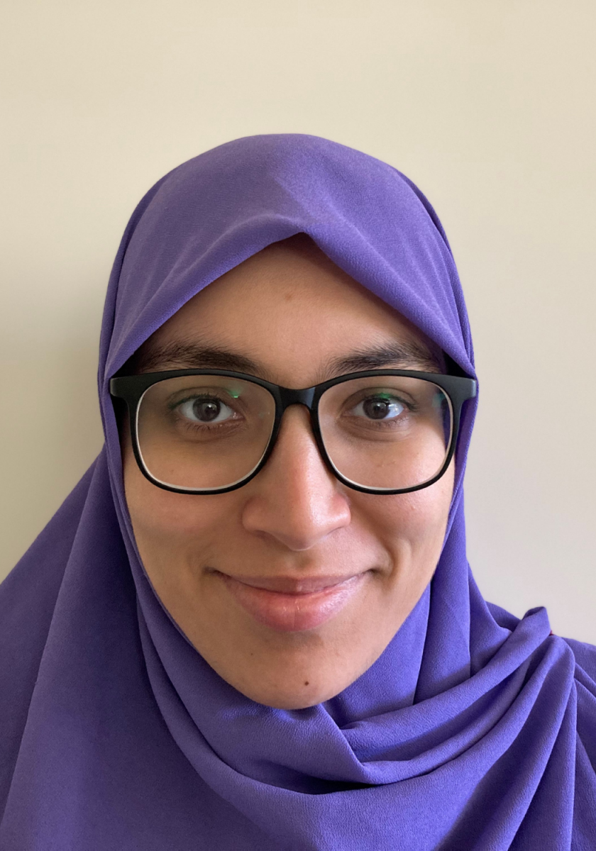 Hanan Jaber headshot. Photo of an Arabic woman with glasses and a purple hijab. 